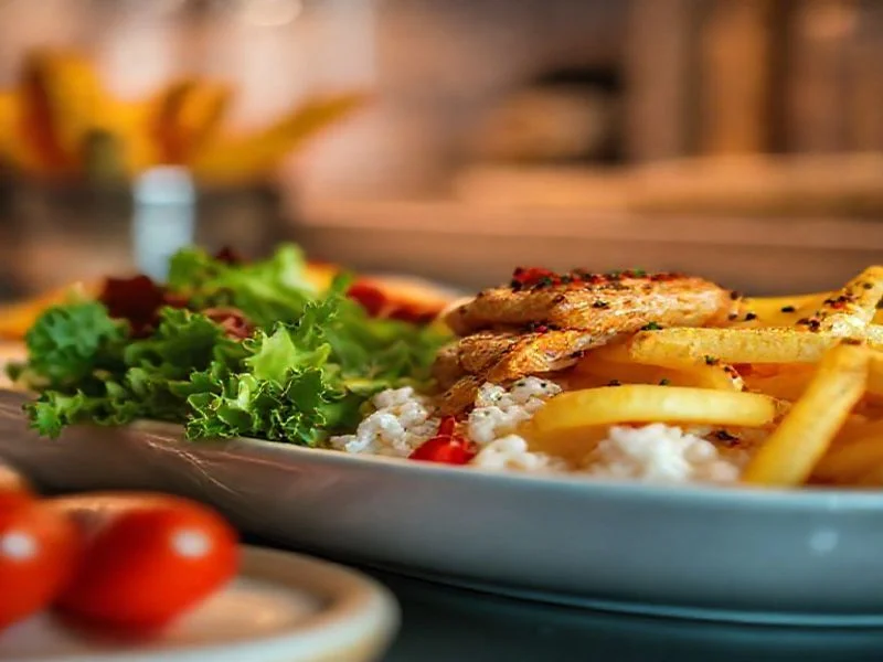Artisan's hands gently kneading a pristine ball of sourdough dough on a flour-dusted antique wooden counter, with subtle steam rising and warm, soft lighting.